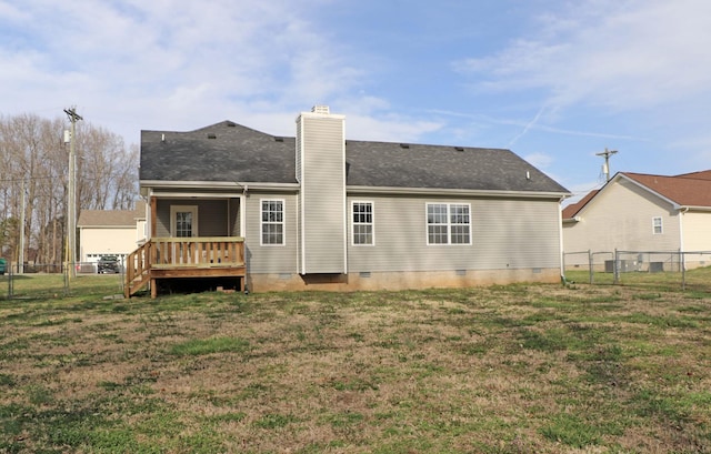 back of house featuring crawl space, a lawn, and fence