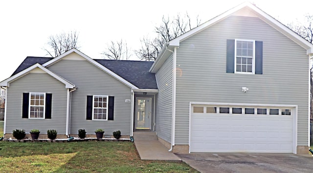 traditional-style house with a garage, driveway, roof with shingles, and a front lawn