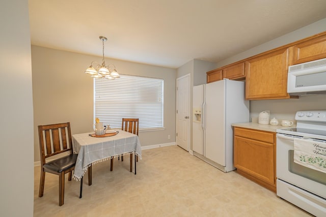 kitchen featuring a notable chandelier, decorative light fixtures, white appliances, light countertops, and baseboards