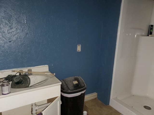 bathroom featuring vanity, tile patterned floors, and a stall shower