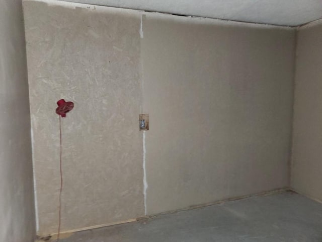 unfurnished room featuring concrete floors