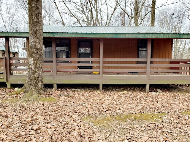 rear view of house featuring metal roof