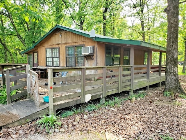 view of outdoor structure with an AC wall unit