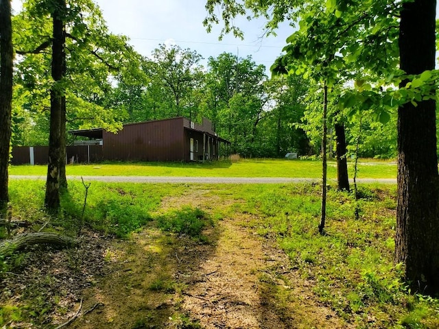 view of yard with a pole building and an outbuilding