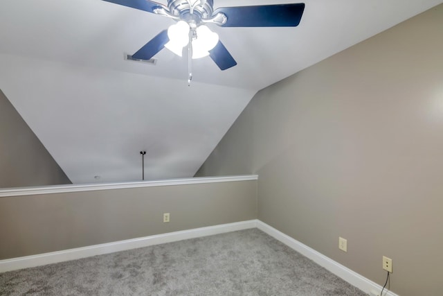 spare room featuring visible vents, ceiling fan, baseboards, lofted ceiling, and carpet floors