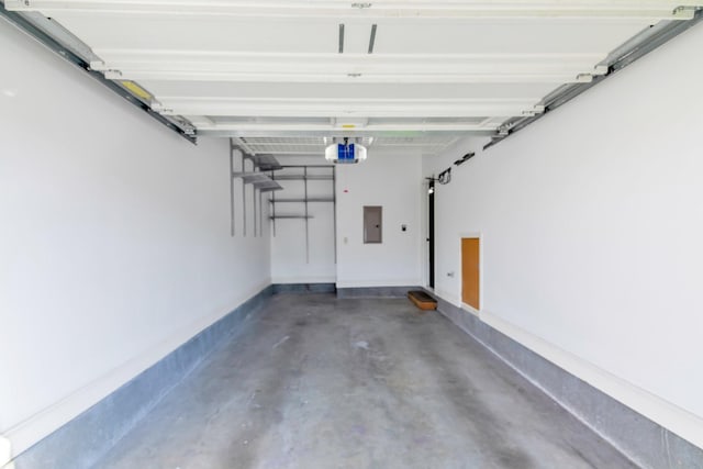 garage featuring electric panel and a garage door opener