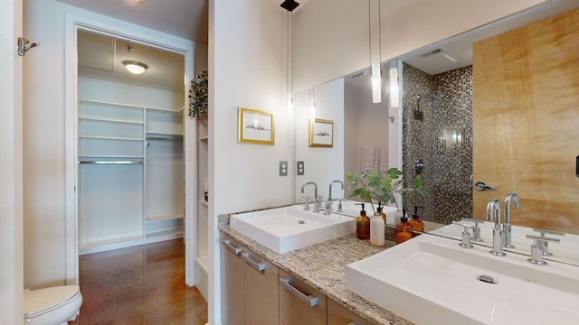 full bathroom featuring a sink, visible vents, toilet, and a tile shower