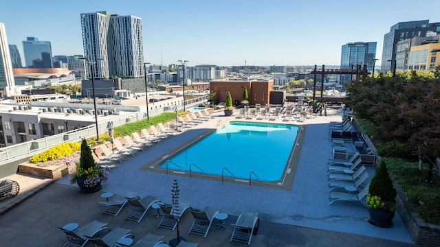 community pool featuring a patio and a city view