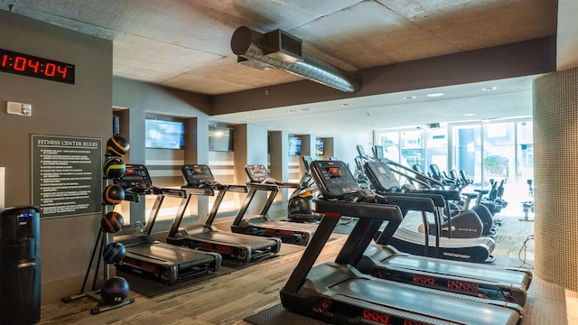 workout area with wood finished floors