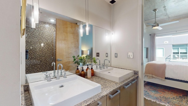 ensuite bathroom featuring double vanity, ensuite bath, ceiling fan, and a sink