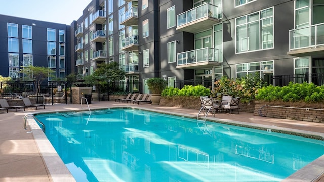 view of pool featuring fence