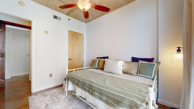 bedroom with visible vents, baseboards, and ceiling fan