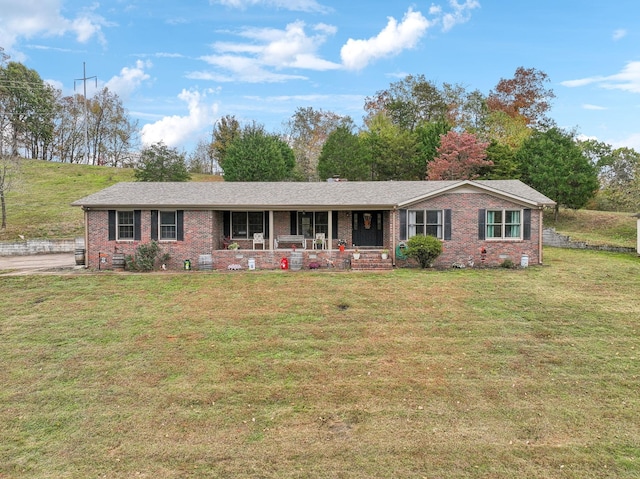 single story home with a front lawn, a porch, brick siding, and crawl space