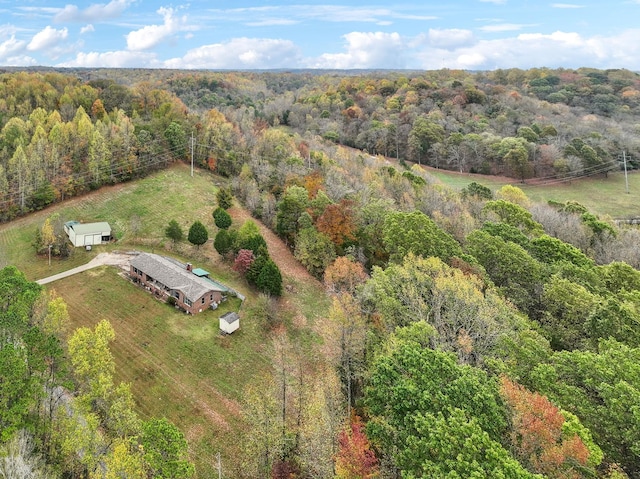 drone / aerial view featuring a forest view