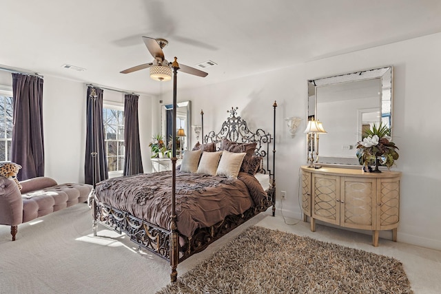 carpeted bedroom featuring visible vents, baseboards, and a ceiling fan