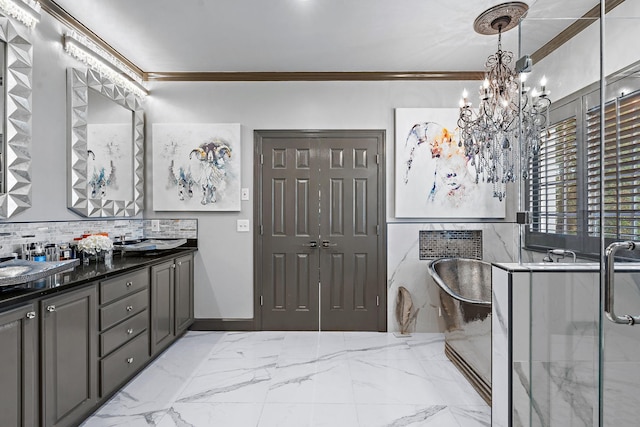 bathroom with double vanity, a freestanding tub, ornamental molding, marble finish floor, and tasteful backsplash