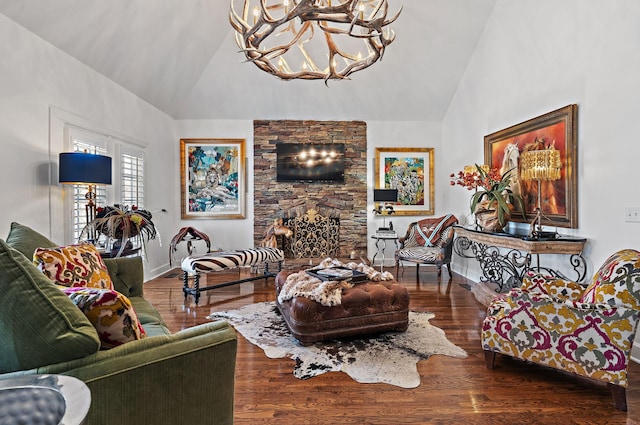 living room with a chandelier, high vaulted ceiling, a stone fireplace, and wood finished floors