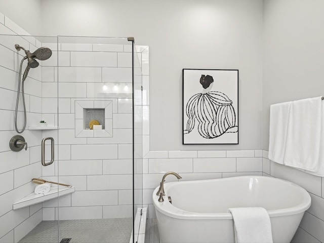 bathroom featuring a soaking tub and a shower stall