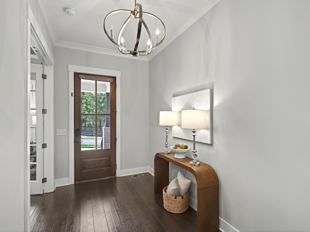 entrance foyer featuring baseboards, crown molding, an inviting chandelier, and hardwood / wood-style flooring