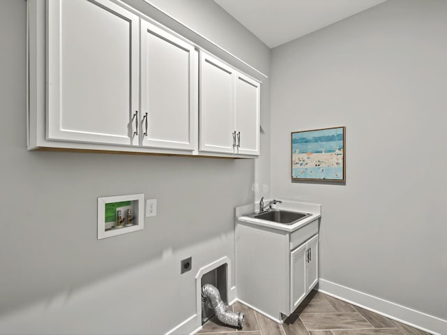 laundry room with electric dryer hookup, washer hookup, a sink, cabinet space, and baseboards