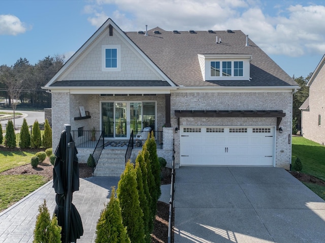 view of front of property featuring concrete driveway, brick siding, and a shingled roof