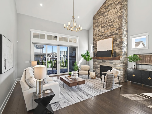 living room featuring hardwood / wood-style floors, baseboards, high vaulted ceiling, a fireplace, and french doors