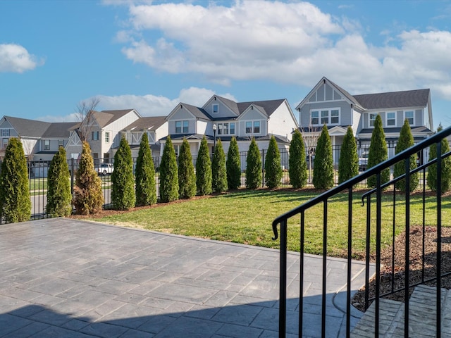 view of patio / terrace with a residential view and fence