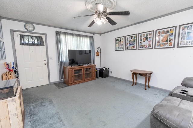 living room with a ceiling fan, baseboards, carpet floors, and a textured ceiling