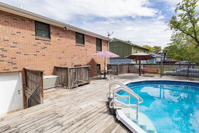 view of pool featuring outdoor dining area and a deck