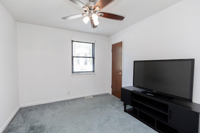 unfurnished living room featuring visible vents, baseboards, ceiling fan, and carpet flooring