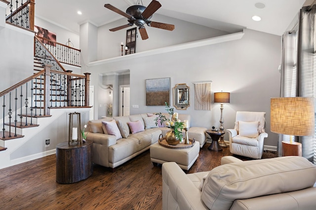 living area featuring stairs, wood finished floors, baseboards, and a towering ceiling