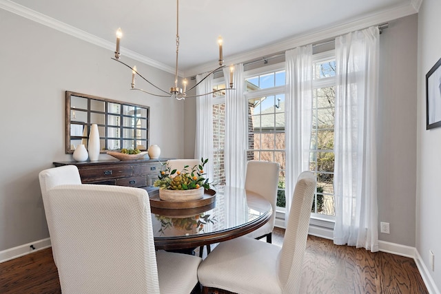 dining room featuring a chandelier, ornamental molding, baseboards, and wood finished floors