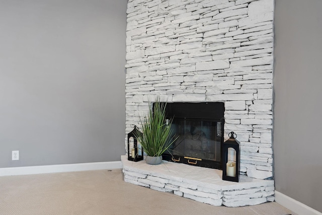 interior details with baseboards, a fireplace, and carpet flooring