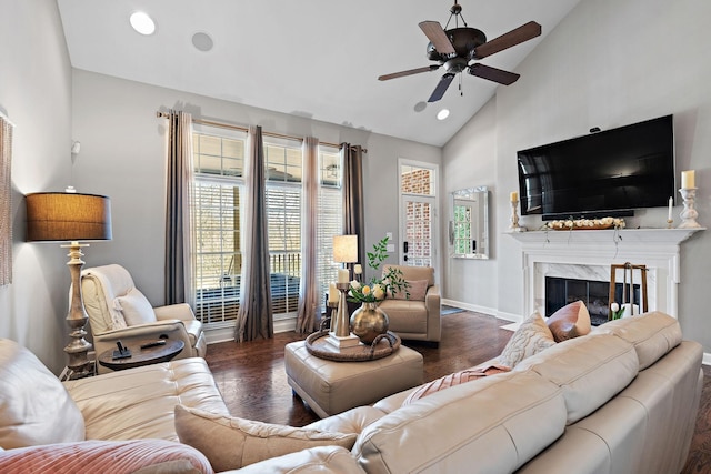 living area with high vaulted ceiling, wood finished floors, recessed lighting, a premium fireplace, and ceiling fan