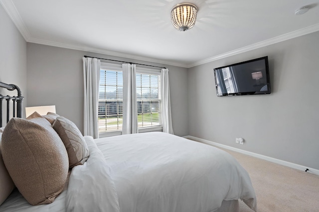 carpeted bedroom with crown molding and baseboards