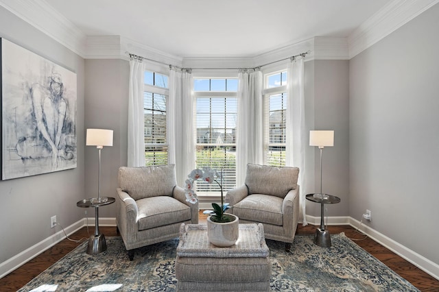 sitting room with crown molding, baseboards, and wood finished floors