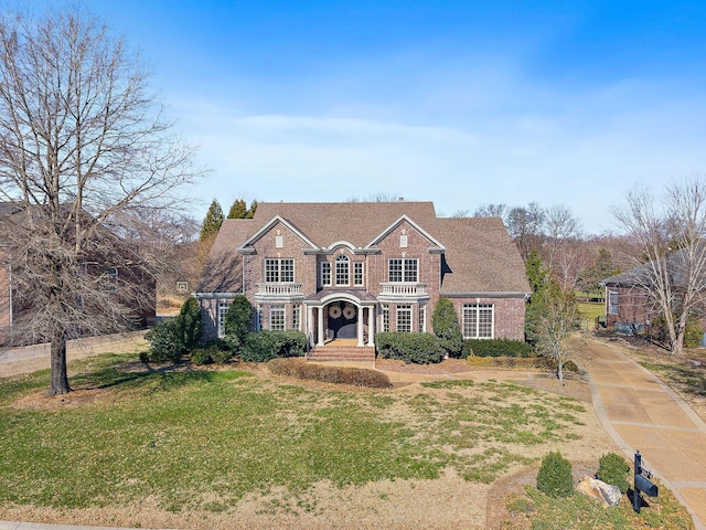 view of front of property with brick siding and a front yard