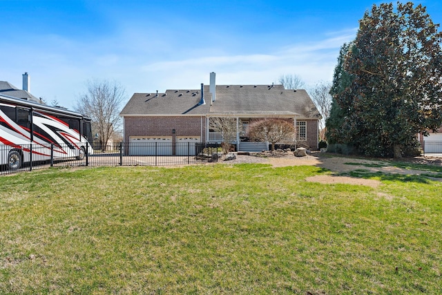 back of property with brick siding, a lawn, a chimney, and fence