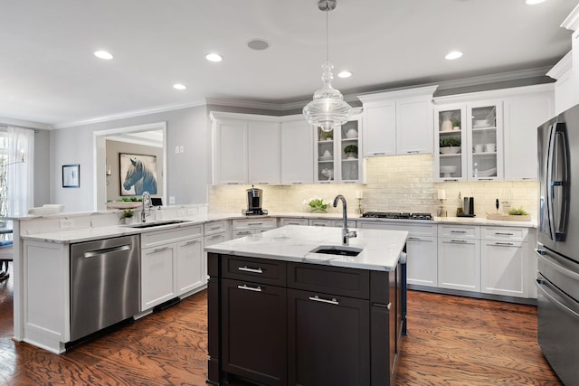 kitchen featuring appliances with stainless steel finishes, white cabinetry, and a sink