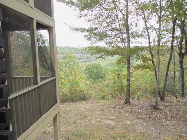 view of yard featuring a forest view