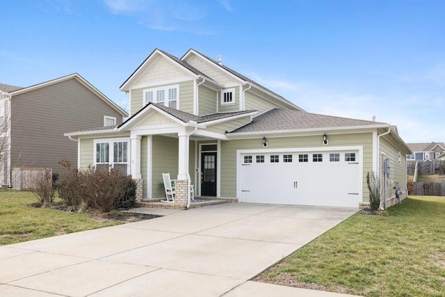 craftsman-style home with a shingled roof, a front lawn, a porch, driveway, and an attached garage