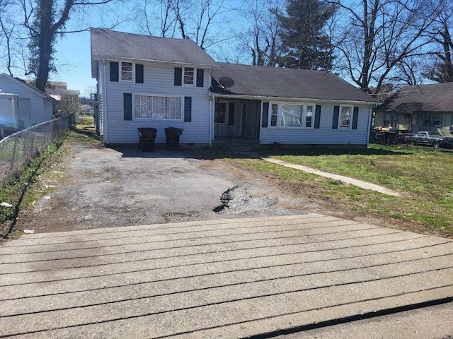 view of front of house featuring a front yard, fence, driveway, and crawl space