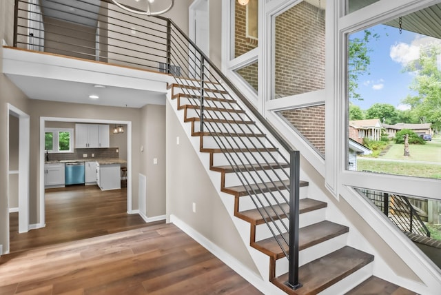 staircase with baseboards and wood finished floors