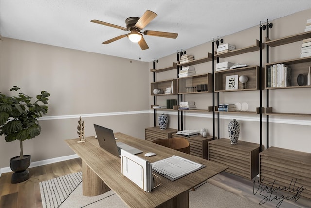 office area featuring baseboards, ceiling fan, and wood finished floors