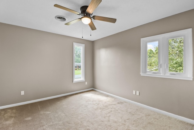 unfurnished room featuring visible vents, ceiling fan, baseboards, and carpet floors