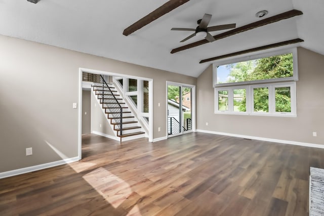 unfurnished living room with stairway, vaulted ceiling with beams, wood finished floors, and baseboards