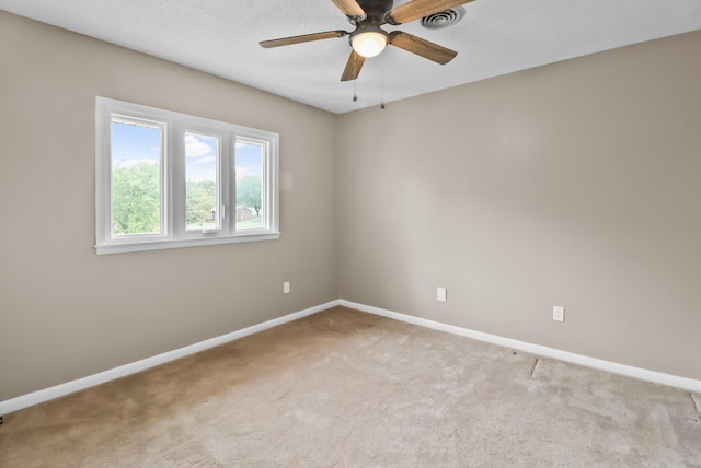 unfurnished room with visible vents, ceiling fan, baseboards, and carpet floors