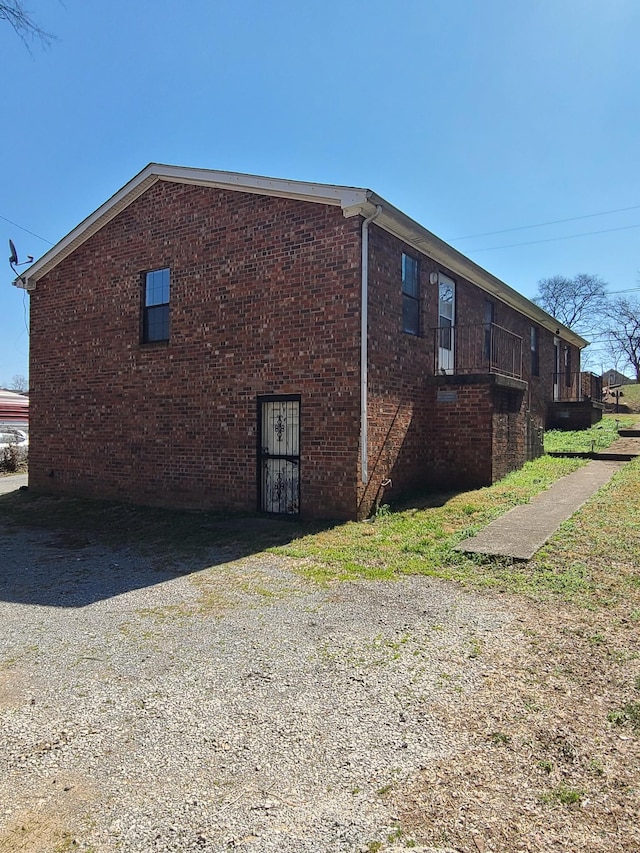 view of property exterior with brick siding