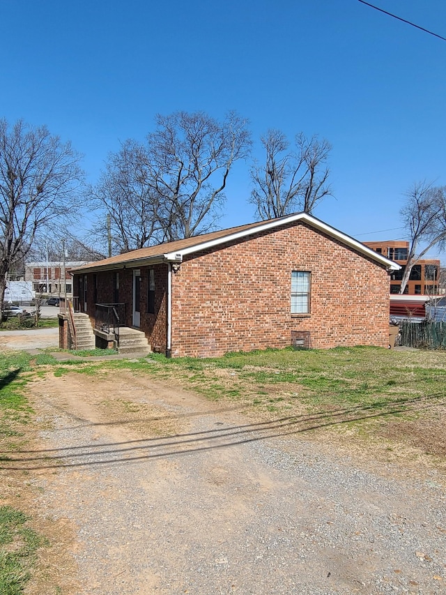 view of property exterior with brick siding