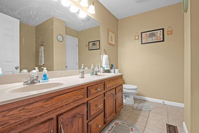 bathroom with tile patterned floors, toilet, visible vents, and a sink